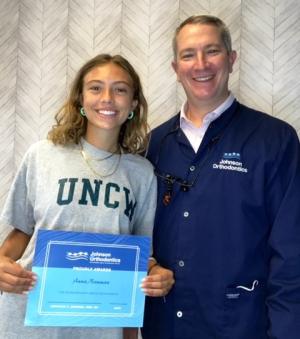 Anna Nauman, left, of Cape Henlopen High School accepts a Johnson Orthodontics Extraordinary Smiles Scholarship from Dr. Jonathan Johnson. SUBMITTED PHOTOS