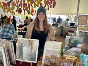 Lewes-based artist Hannah Whidder stands among her works for sale.