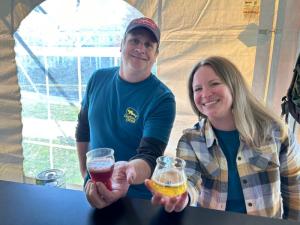Amber Otteni and J.D. McConaughy show off Colderest IPA, a specialty beer made for the festival.