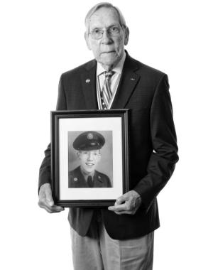 U.S. Air Force veteran Charles Garrod poses with a framed photograph of himself from his days in the service. SUBMITTED PHOTOS