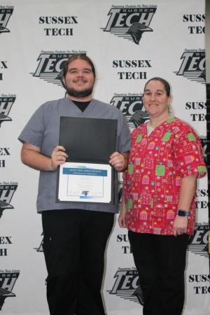 Sussex Tech Ad Ed graduate Ethan Flynn, left, receives congratulations from Jennifer Ganly, phlebotomy instructor.