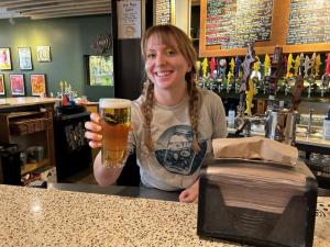 Pouring a glass of 302 Lager is Dogfish Head bartender Alli Bagshaw.