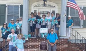 Taking part in Turn the Town Teal in Milton are in back (l-r) Cindy Verdi, Danielle Mummert, Georgianna Jackson and Mary Molettiere. In the middle are Charlene Merk, Carol Capobianco, Ellen De Rosa, Maida Graves, Peg Lederman, Debby Pecoraro, Diane Bitterle and Sally Oberle. In front are  Sen. Russell Huxtable, R-Lewes; Chrissy O'Connor; Milton Mayor John Collier. SUMBITTED PHOTO