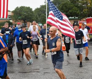 Allen Jackson shows the pride of Station 85 during a previous Run, White & Blue 5K.
