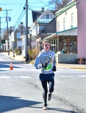 Ryan Baker runs in downtown Milton sporting his Lehigh swag.