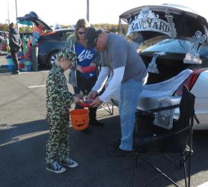 Gathered at the graveyard car are (l-r) Wyatt Wilkinson, Elks Past Exalted RulerJoy Schreck and Leading Knight Marty Schreck.
