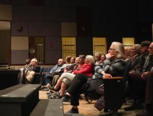 Audience members watch Gerald Dickens’ rendition of “A Christmas Carol.”