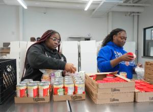 Kiaira Wheeler, left, and Zoe Garrett, both Delaware State University students and members of Sigma Gamma Rho, sort food at the Martin Luther King Jr. Day of Service at the Food Bank of Delaware.