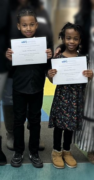 Milton Elementary School honorees Kade Wilkerson, left, and Olivia Ohimor display their certificates of recognition from the Southern Delaware Alliance for Racial Justice.