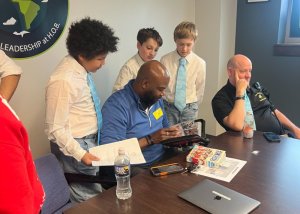 Exploring a manga card collection together are (l-r) Xavier Walters, Maverick Ward, Luke Bradney, Brian Tatem and Constable George Rath.