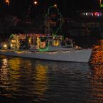 Miss Maggie is lit to celebrate the 100th anniversary of the Girl Scouts. The boat, captained by Dean Johnson, won top honors in the large power boat category. BY RON MACARTHUR