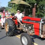 Dick Bryan hauls a load of fresh Historic Lewes Farmers Market volunteers through the Doo-Dah Parade route.