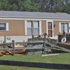 A section of roof came to rest in the front yard of a neighboring home. BY RON MACARTHUR