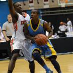 Cape senior forward Jon Jon Warren drives to the basket past Knights guard Omari George. BY DAN COOK