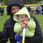 Held by her mom, Adeline, nine-month-old Lilly June Farhi seems more interested in the kite string than the kite. BY RON MACARTHUR
