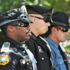 Lt. Derrick Harvey of Milton Police, Cpl. Curtis Sauve of Rehoboth Police and Sgt. Cliff Dempsey of Dewey Police stand at attention as part of the color guard. BY NICK ROTH