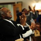 Rev. Ron Houston of St. John 2nd Baptist Church sings along with the choir. BY DAN COOK