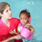 YMCA volunteer Erin Bryan calms Jayla Johnson,3, during the WLSL. BY DAN COOK
