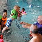 Leo Barr jumps into the waiting arms of volunteer John Zinsmeister. BY DAN COOK