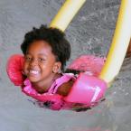 Tiyan Milbourne has a great time on her pool noodle. BY DAN COOK