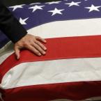 Vice President Joe Biden rests his hand on his son's casket. BY ASSOCIATED PRESS