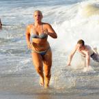 Sea Colony Beach patrol junior guard Tessa Elling exits the wild surf during the sprint swim competition. BY DAN COOK