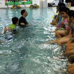 Children from La Rosa in Georgetown get a lesson from instructor Monique DeMay before entering the pool. BY DAN COOK