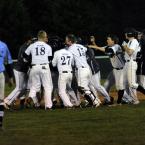 After a strong performance on the mound a dejected David Erickson walks off as the Bucs celebrate their 2-1 victory. BY DAN COOK