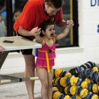 YMCA aquatics coordinator Lydia Schmierer comforts Camila Caceres-Riggs, 4, as she enters the pool. BY DAN COOK