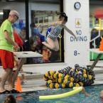 Amelia Robertson, 3, jumps in under the watchful eye of volunteer John Zinsmeister. BY DAN COOK