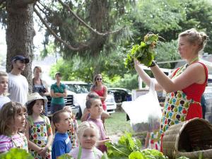Katie Freer shows off some fresh produce at a local farmers market to a group of sprouting chefs. COURTESY SPROUTING CHEFS