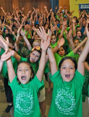Members of the Richard Shields Elementary School chorus act out to the song, "YMCA," during the annual spring concert. Among the dozens with raised arms are (l-r) in the second row, Riley Roberts and Juliana Cincinato and in the front, Martha Billups and Bella Myers. BY RON MACARTHUR