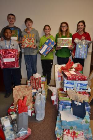 Eagle's Nest middle schoolers display some of the Christmas gifts they gathered for their adopted families. In back (l-r) are Brandon Pepper, Ryan Timmons, Nikki Phillips, Alyssa Purnell and Gabby Book; in front is Caleb Jones. SOURCE SUBMITTED