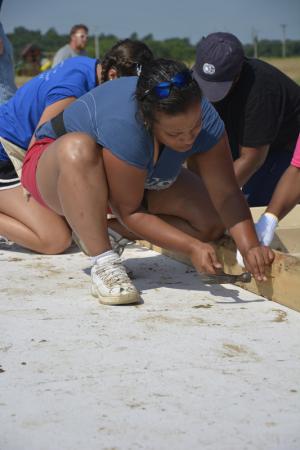 Future homeowner Paula Puello works on her own house alongside the volunteers for the day. PHOTOS BY LEXI COON