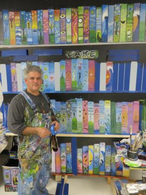 Artist John Donato organizes the collective mural project at Millsboro Middle School, helping staff and students prepare, plan and paint their mural to illustrate the school's CARE motto. BY MOLLY MACMILLAN