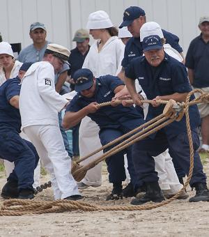 Delaware Seashore State Park interpreters and U.S. Coast Guard officers demonstrate how the lines are attached to an anchor on shore before the rescue begins. This image is part of a series that earned Cape Gazette photographer Deny Howeth a first place for Photo Series in the MDDC Press Association's annual editorial contest. See more photographs at capegazette.com. BY DENY HOWETH