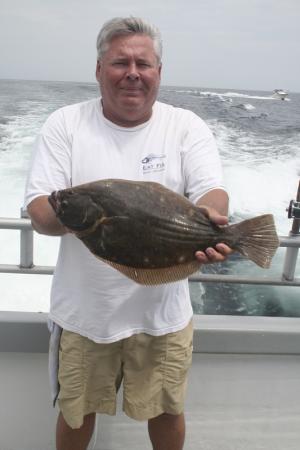 Dan Lynch with his pool-winning flounder. BY ERIC BURNLEY