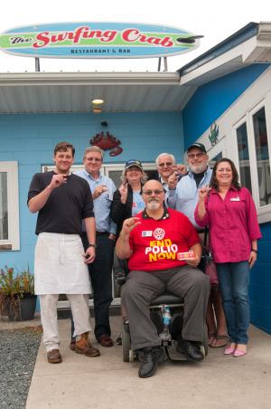 The Surfing Crab hosted the Crab Feast at Surfing Crab to Eradicate Polio Oct. 25. Showing the "We are this close" sign are (l-r) Donnie Vechery, owner of The Surfing Crab; Jack Riddle, Rotary assistant district governor; Jen Reider, former Delaware district governor; Dave Keller, Lewes-Rehoboth Rotarian and polio survivor; Dr. Phil Allen, Rehoboth Sunrise Rotarian PolioPlus coordinator; Tamara Morgan, Lewes-Rehoboth Rotary president; and seated is John Nanni, Middletown-Odessa Rotary Club and District 7630 PolioPlus chairman. BY DENY HOWETH