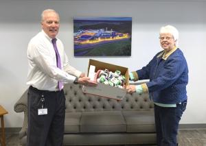 From a distance, CHEER Community Relations Director Carolyn O’Neal accepts a box of thermometers from Sussex Tech Superintendent Stephen Guthrie. SUBMITTED PHOTO