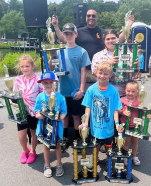 Some of the winners include in back (l-r) William Elliott, Paradise Companies founder Al Tortella and Aryana Vazquez. In front are Alyssa Brown, Greg Nolan, Charlie Noll and Brinley Pry. Noll was the grand champion of the event, catching 73 fish. All told, 103 kids signed up to participate. The event raised $500 for the Indian River Volunteer Fire Department. SUBMITTED PHOTOS