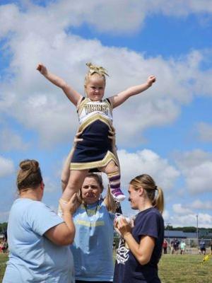 Everleigh Fletcher, 5, does a cheer routine with her Pop Warner coaches (l-r) Tiffany Barlow, Dana Biggs and Brittany Cannon. SUBMITTED PHOTO